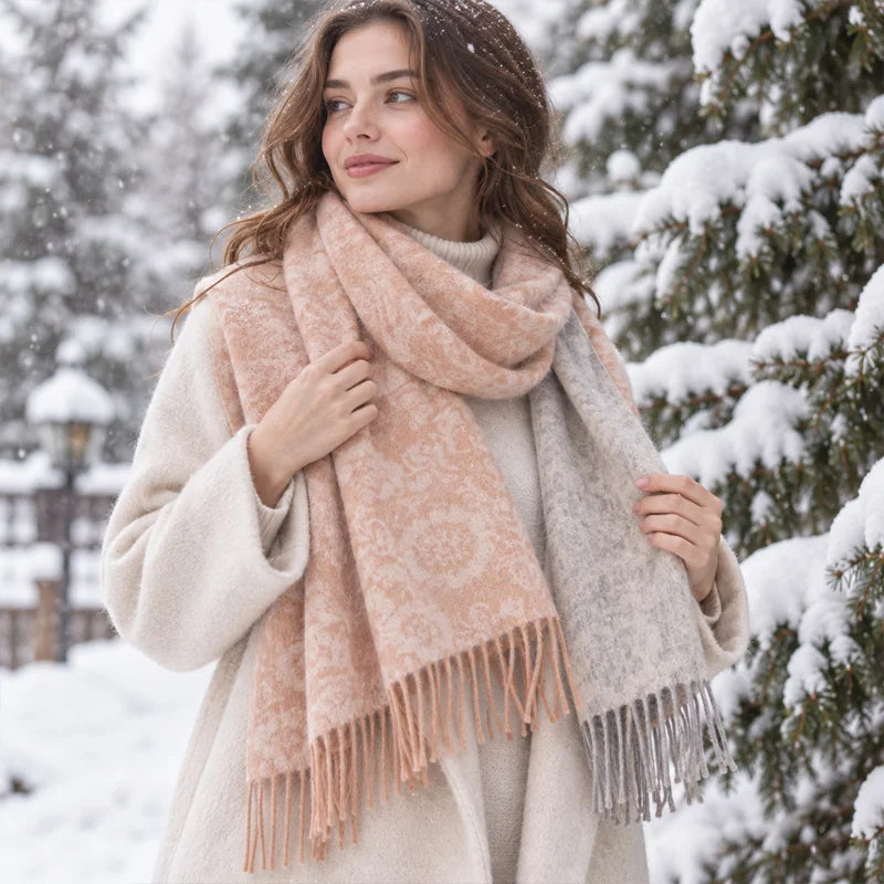 Woman wearing peach floral wool scarf beside snow covered trees