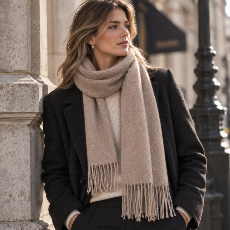 Woman wearing taupe cashmere scarf over a dark coat